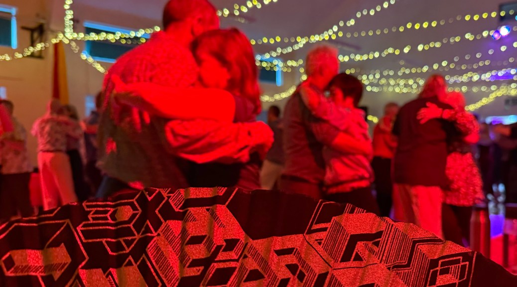 Septonathon 2025 (photo shows an in-focus fan with out-of-focus dancers beyond)